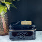 Authentic CHANEL Vanity Cosmetic Case crafted of Black Patent Leather